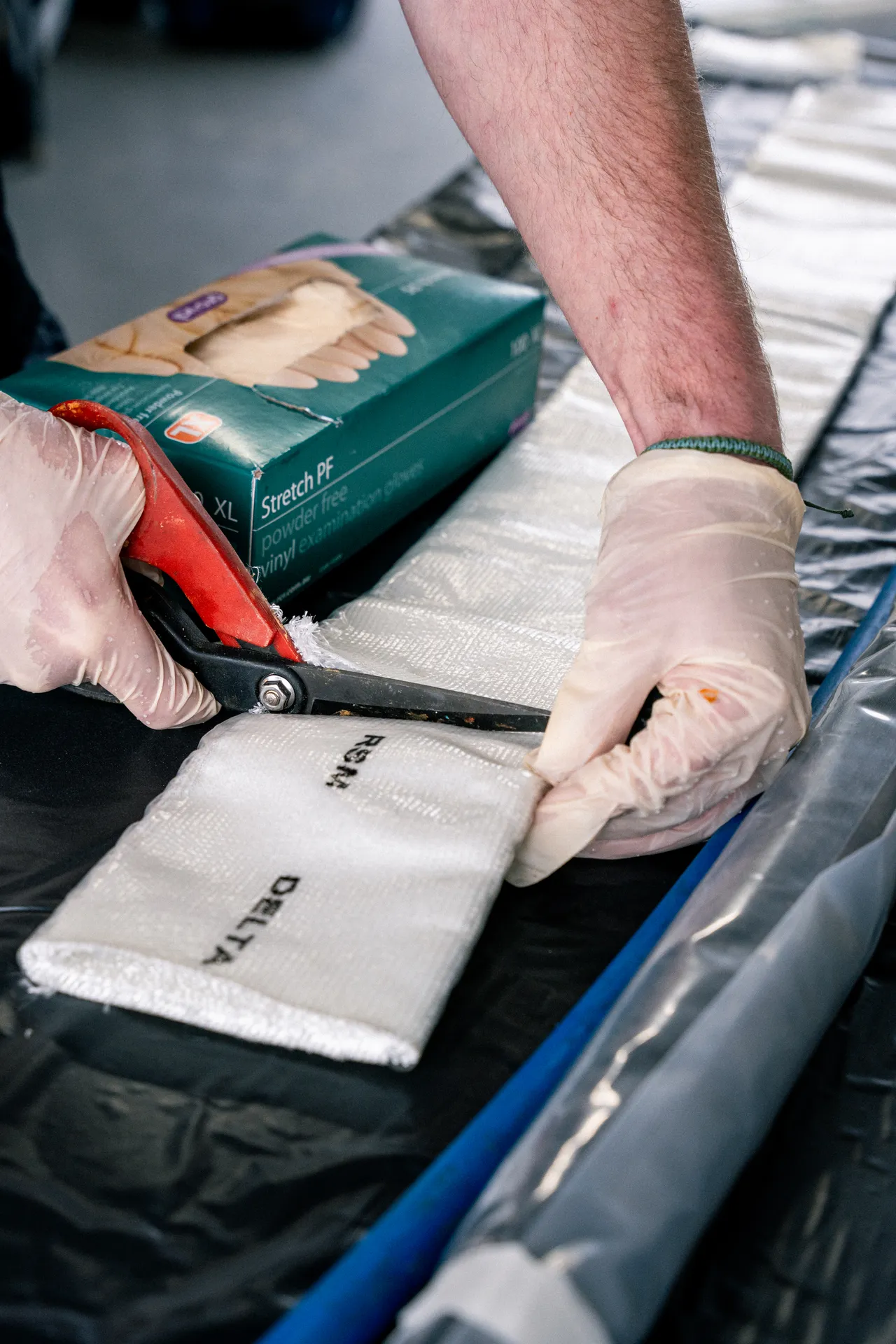 A Mr Drainage technician cutting a pipe-relining liner to length